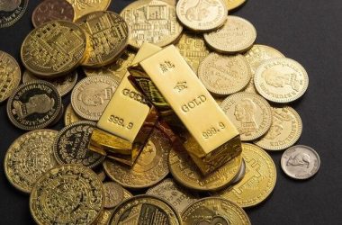 Two gold bars above scattered coins