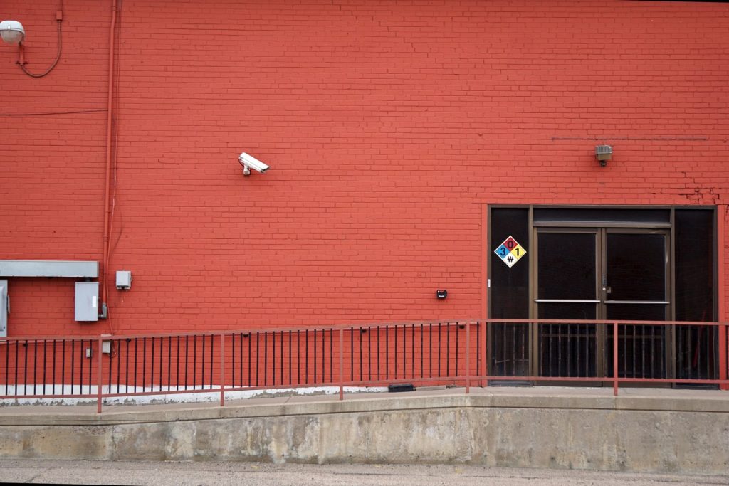 Security camera and rear entrance on a commercial building: In the Year Ahead, Just Under a Third of British Businesses Will Face Crime