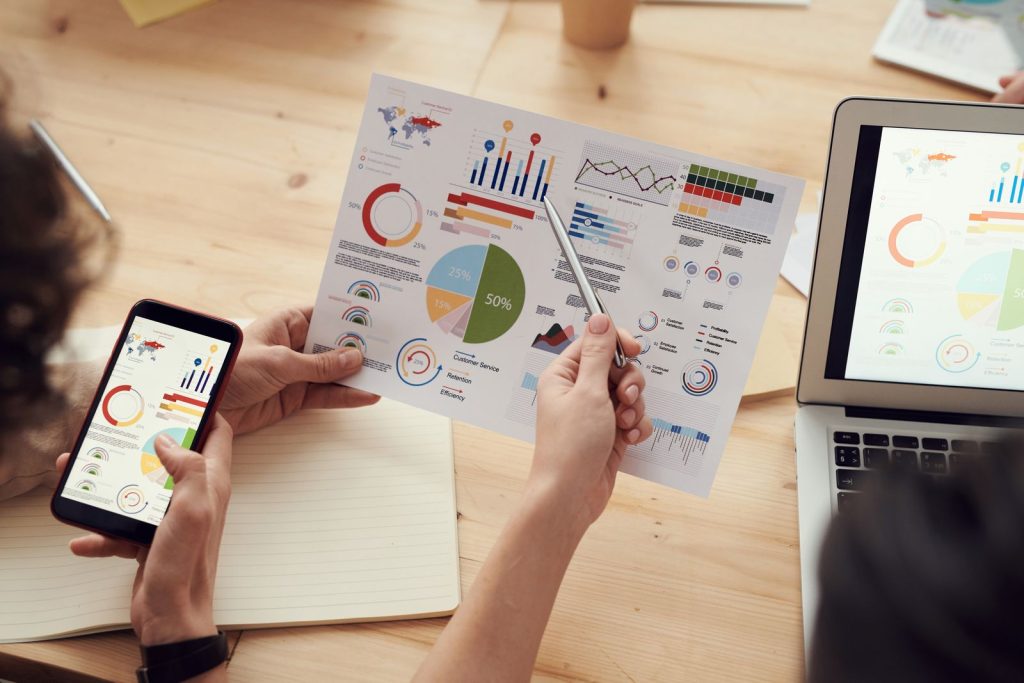 The Best Search Marketing Partners Know Your Industry Before They Pitch: marketing specialists reviewing SEO and campaign analytics charts at a desk